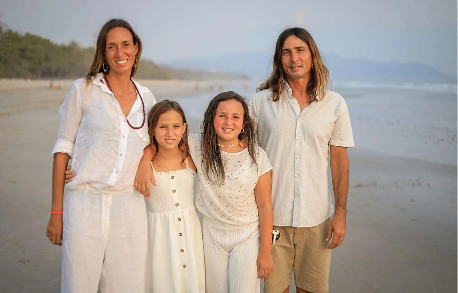 Marianne, Rob and their two daughters on the beach