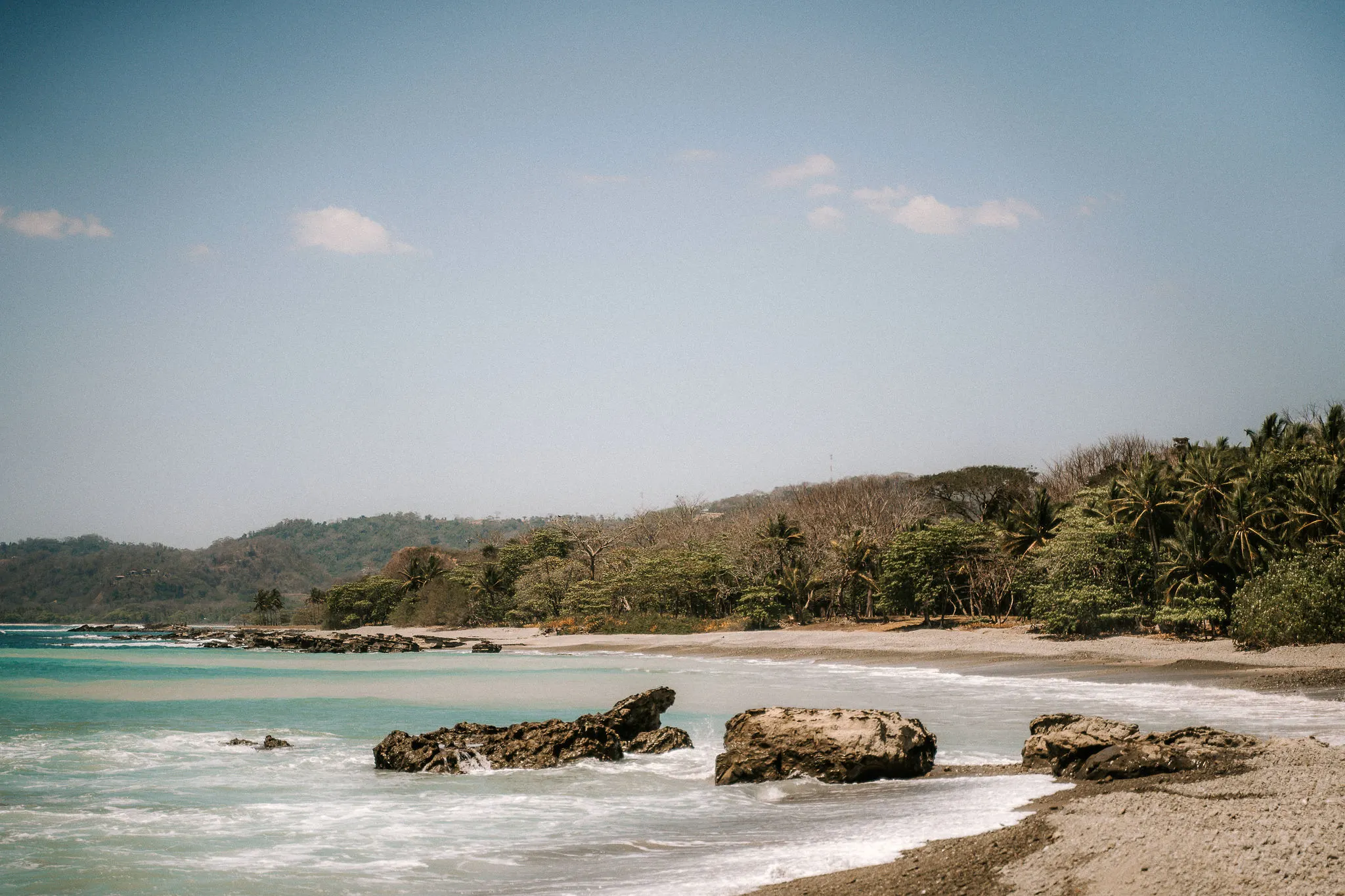 Turquoise water and rocks along the Santa Teresa shore